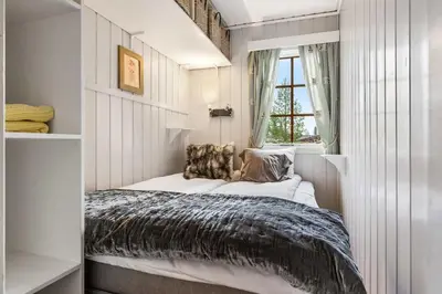 a small bedroom with a bed and a window at Fageråsen 209 by Vacation Trysil in Trysil