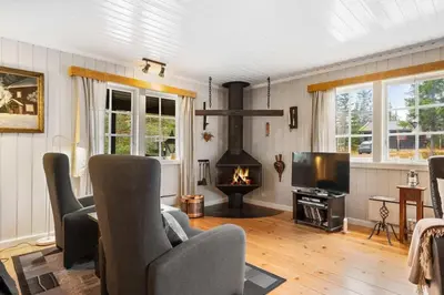 a living room with a fireplace and a tv at Fageråsen 209 by Vacation Trysil in Trysil