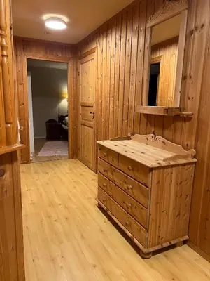 a large bathroom with wooden walls and a large tub at Det vesle huset på Lysåker in Nord-Fron