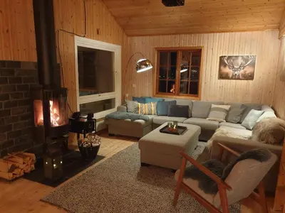 a living room with a couch and a fireplace at Filefjellhytta ved Tyin og Jotunheimen Ski in og ski out til alpinanlegg og skiløyper in Tyinkrysset