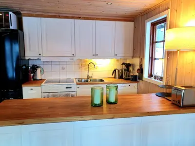 two green glasses sitting on a wooden counter in a kitchen at Filefjellhytta ved Tyin og Jotunheimen Ski in og ski out til alpinanlegg og skiløyper in Tyinkrysset