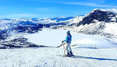 a person on skis on top of a snow covered mountain at Filefjellhytta ved Tyin og Jotunheimen Ski in og ski out til alpinanlegg og skiløyper in Tyinkrysset