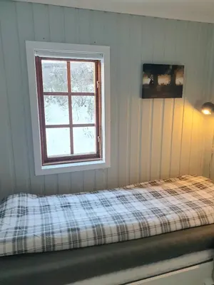 a bedroom with a bed and a window at Filefjellhytta ved Tyin og Jotunheimen Ski in og ski out til alpinanlegg og skiløyper in Tyinkrysset
