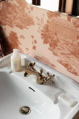 a bathroom sink with a soap dispenser on it at Bryggen Boutique l Stay Uniquely l 2 min to Floyen in Bergen
