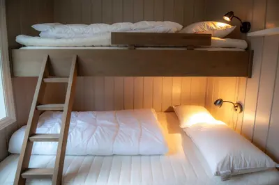 a bedroom with two bunk beds and a ladder at Trysilfjellet Nord 985A in Trysil