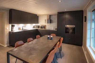 a kitchen with a table and chairs in a kitchen at Trysilfjellet Nord 985A in Trysil