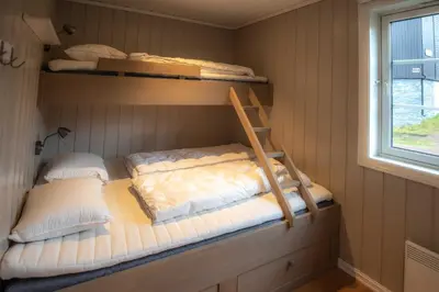 a bedroom with two bunk beds and a window at Trysilfjellet Nord 985A in Trysil