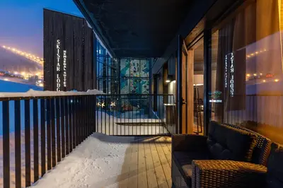 a balcony of a building with snow on the ground at Brand new luxury apartment by the slopes, Hemsedal in Hemsedal