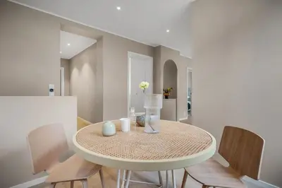 a dining room with a round table and chairs at Beautiful 3 room apartment centrally located in Sandviken in Bergen