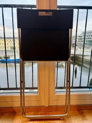 a black chair sitting in front of a window at Riverside family-friendly Mini Penthouse in Trondheim