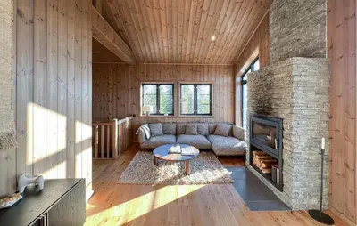 a living room with a couch and a fireplace at Stunning Home In Noresund With Sauna in Noresund