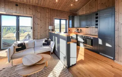 a kitchen with a couch and a table in a room at Stunning Home In Noresund With Sauna in Noresund
