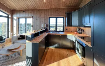 a kitchen with black cabinets and a counter top at Stunning Home In Noresund With Sauna in Noresund
