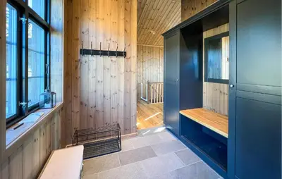 a room with wood paneling and a hallway with a bench at Stunning Home In Noresund With Sauna in Noresund