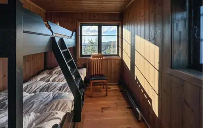 a bedroom with a bunk bed and a window at Stunning Home In Noresund With Sauna in Noresund