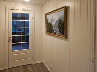 a painting hanging on a wall next to a door at Charming Farm Stay On Averøy Island in Averoy