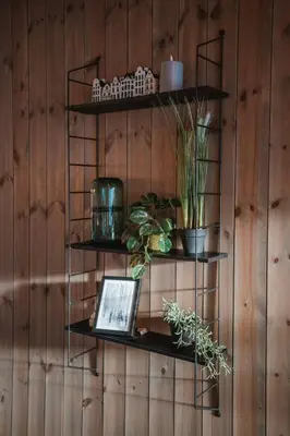a shelf with a laptop on a wooden wall at Cozy Family Cabin Ski centre, shuttle bus in Noresund