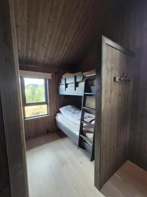 a room with a bunk bed and a window at Modern mountain cabin with panorama view in Eggedal
