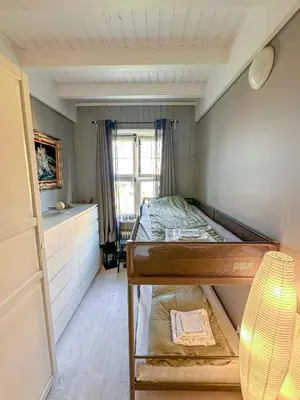 a bedroom with a bunk bed and a window at Modern and spacious home in Trondheim