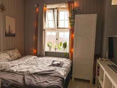 a bedroom with a bed in front of a window at Modern and spacious home in Trondheim
