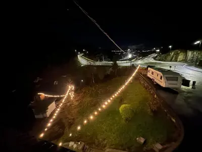 an aerial view of a park with lights at night at Aurora Caravan Near Bergen in Strusshamn