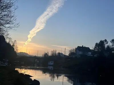 a view of a river with a smoke trail at Aurora Caravan Near Bergen in Strusshamn