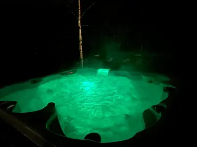 a hot tub in the dark at night at Aurora Caravan Near Bergen in Strusshamn