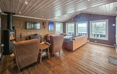a living room with a couch and a table at Cozy Home In Ulnes With Sauna in Ulnes