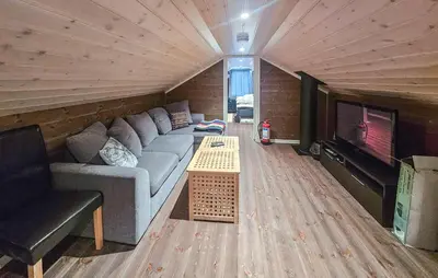 a living room with a couch and a table in front of a tv at Cozy Home In Ulnes With Sauna in Ulnes