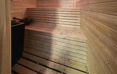 a wooden tub in a room with a wooden wall at Cozy Home In Ulnes With Sauna in Ulnes
