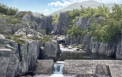 a river with a waterfall in a rocky canyon at 3 Bedroom Stunning Home In Hovden I Setesdal in Hovden