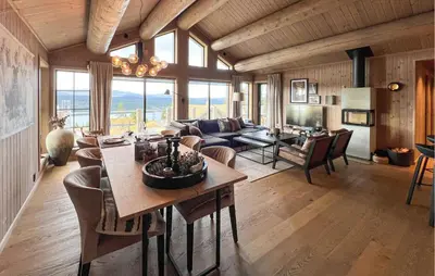 a living room with a couch and a table at Amazing Home In Gålå With Sauna in Gålå