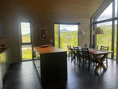 a kitchen and dining room with a table and chairs at The Lookout At Beitostølen in Beitostøl