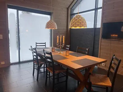 a dining room with a wooden table and chairs at The Lookout At Beitostølen in Beitostøl