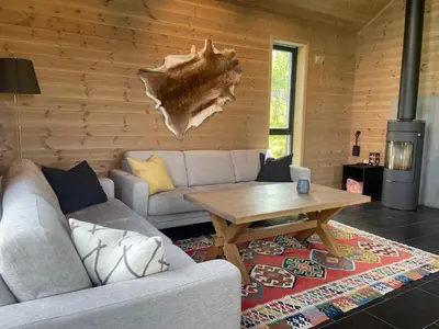 a living room with a couch and a table at The Lookout At Beitostølen in Beitostøl