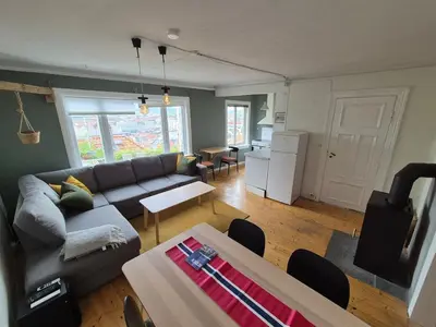 a living room with a couch and a table at 2-roms leilighet med spektakulær utsikt og privat hage in Bergen