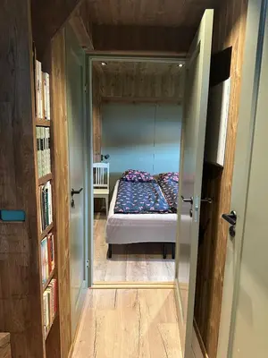 a bedroom with a bed in a small room at Architectural gem with fjord view in Holmedal