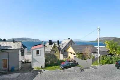 a row of houses with a car parked in the street at Centrum Apartment in Ålesund