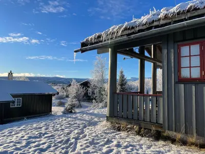 a house in the snow with a view at Koselig Og Sentral Hytte Med Peis Og Badstue in Beitostøl
