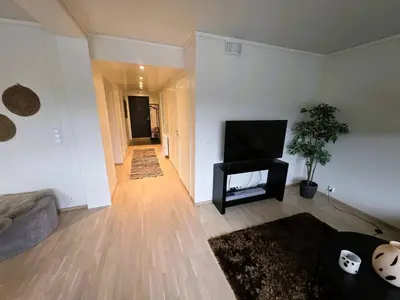 a living room with a flat screen tv and a couch at Nice apartment in the center of Trysil 403 in Trysil