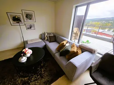 a living room with a couch and a large window at Nice apartment in the center of Trysil 403 in Trysil