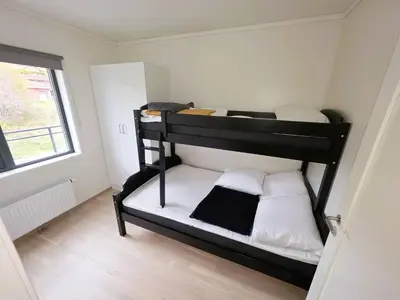 two bunk beds in a small room with a window at Nice apartment in the center of Trysil 402 in Trysil