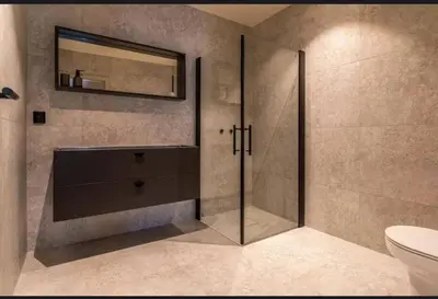 a bathroom with a shower with a mirror and a toilet at New house in the center of Trysil in Trysil