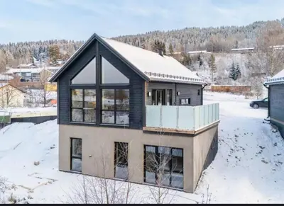a house covered in snow with a roof at New house in the center of Trysil in Trysil