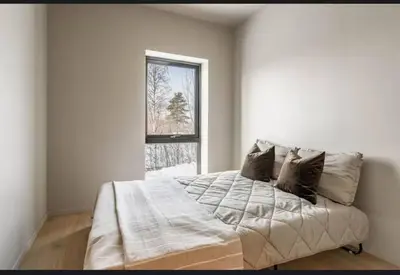 a bedroom with a large bed with a window at New house in the center of Trysil in Trysil
