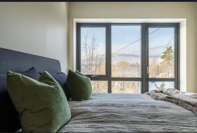 a bedroom with a bed with a large window at New house in the center of Trysil 2 in Trysil