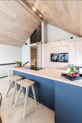 a kitchen with a blue counter and wooden ceilings at New house in the center of Trysil 2 in Trysil