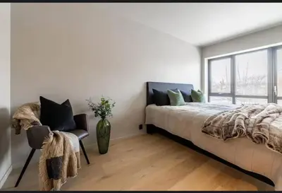 a bedroom with a bed and a vase of flowers at New house in the center of Trysil 2 in Trysil