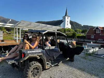 a group of people sitting in a utility vehicle at Vár Seaside Cabin in Stavang