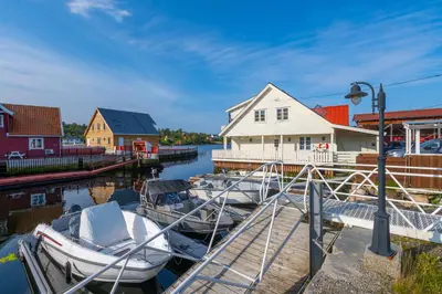 a couple of boats are docked at a dock at Vár Seaside Cabin in Stavang